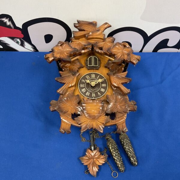 Vintage Kaiser Black Forest cuckoo clock with carved details.