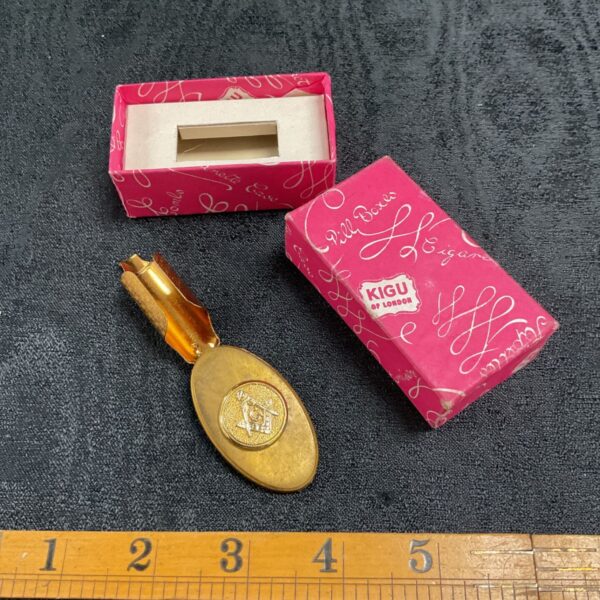 Vintage Kigu lipstick holder with original box and ruler for scale.