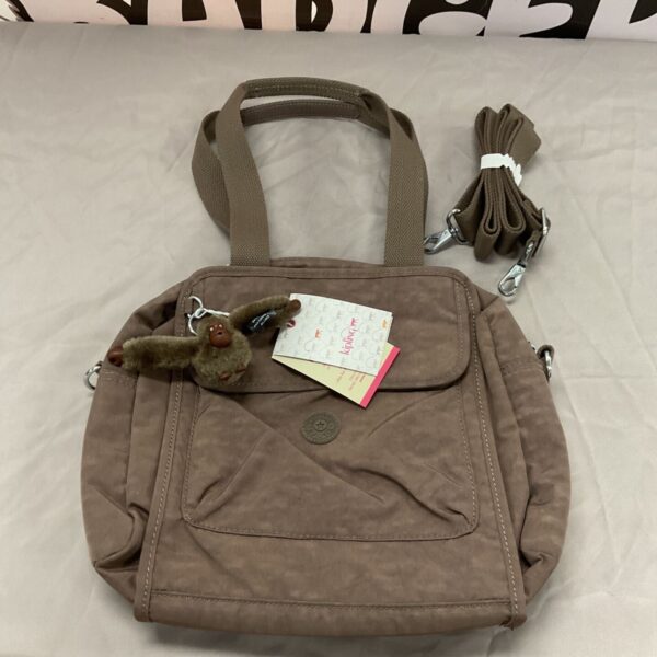 Brown Kipling Alanis handbag with monkey keychain and tags.