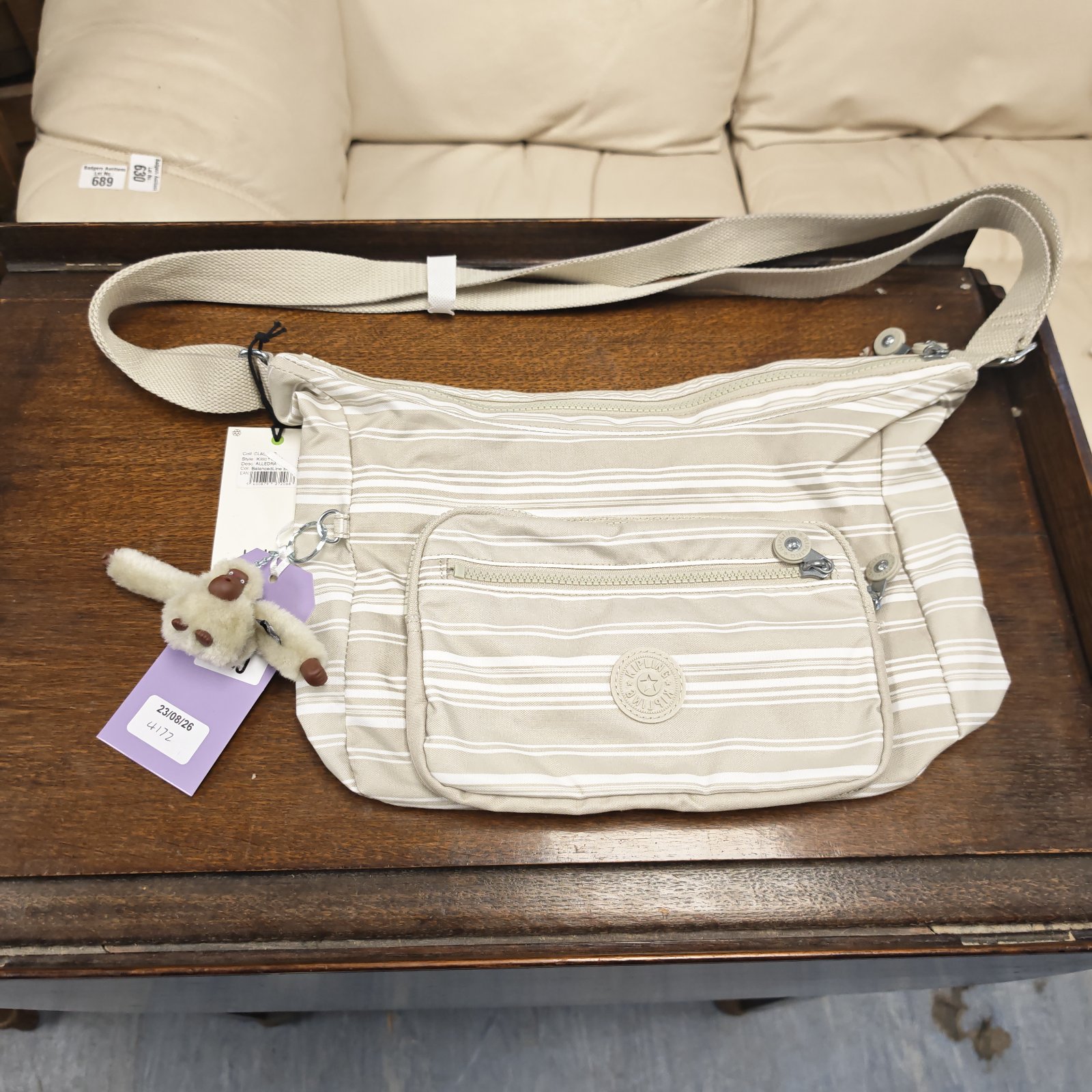 White and beige striped Kipling shoulder bag with tags.