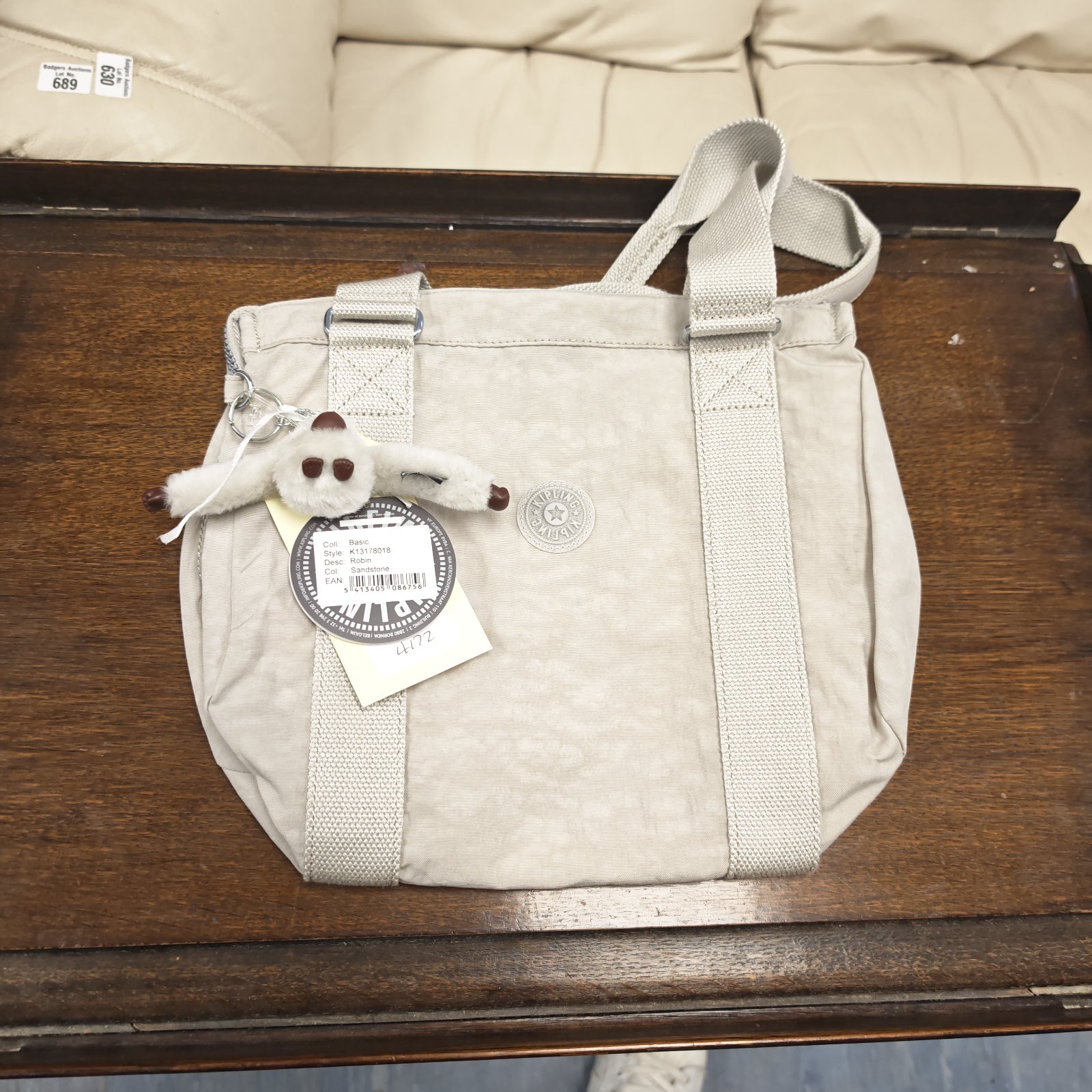 Vintage beige Kipling handbag with original tags attached.