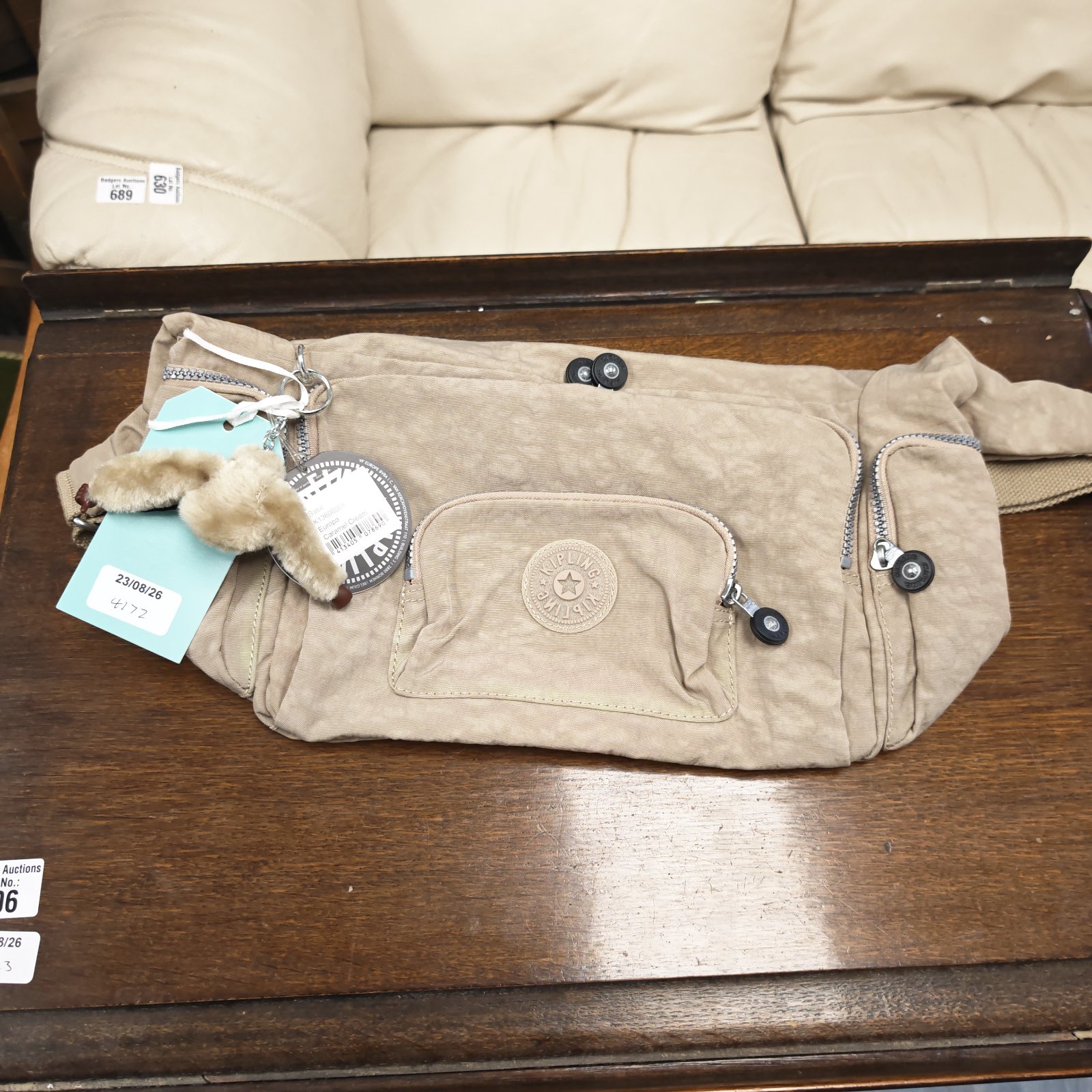 Caramel cream Kipling shoulder bag with tags attached.