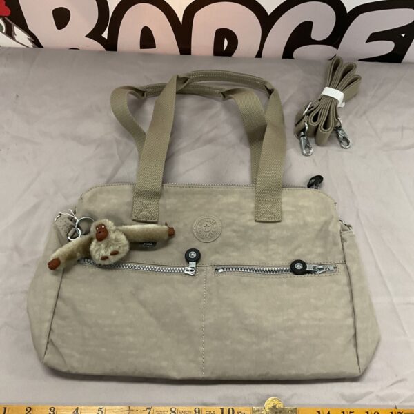 Kipling handbag with monkey charm, a stylish ladies shoulder bag.