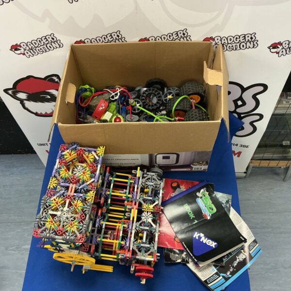 Large assortment of colourful KNEX building pieces and wheels.