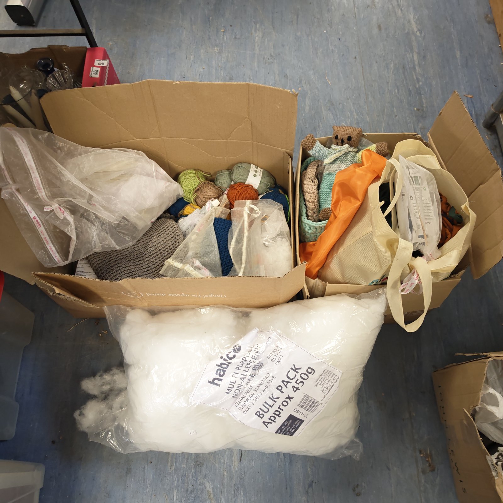 Bulk lot of colourful knitting wool and crafting supplies.