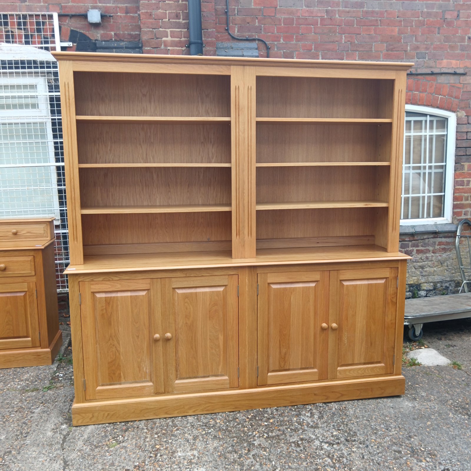 Large oak dresser with cupboard and shelving for storage and display.
