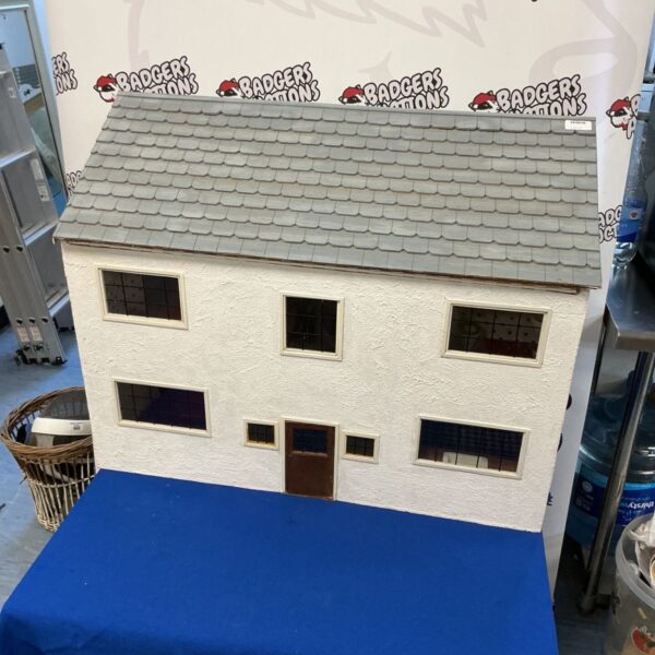 Large scratch built dolls house with tiled roof and windows.