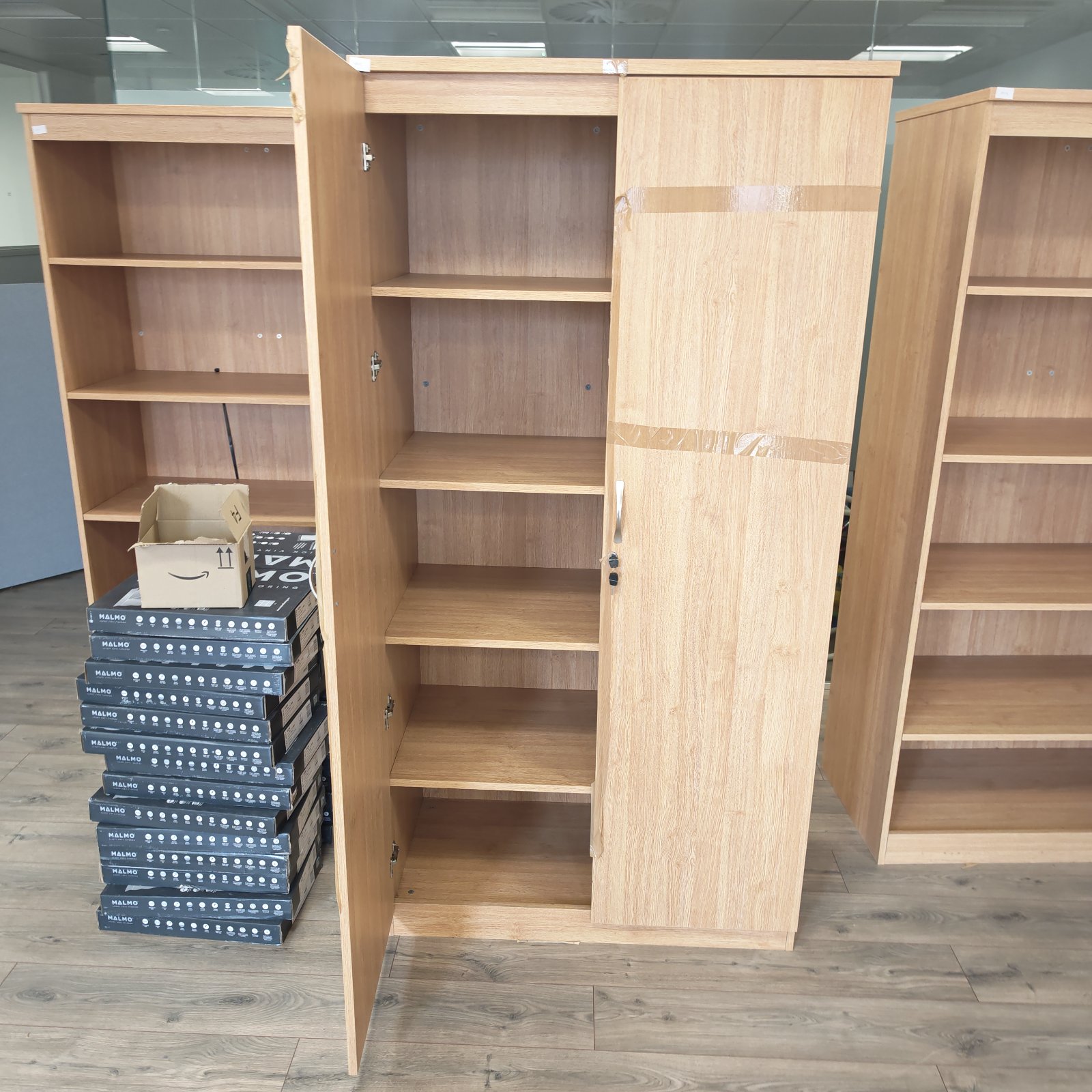 Large wooden office filing cabinet with keys, ideal for office storage.