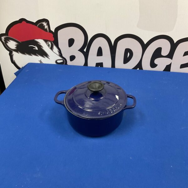 Vibrant red Le Creuset cast iron casserole dish with lid.