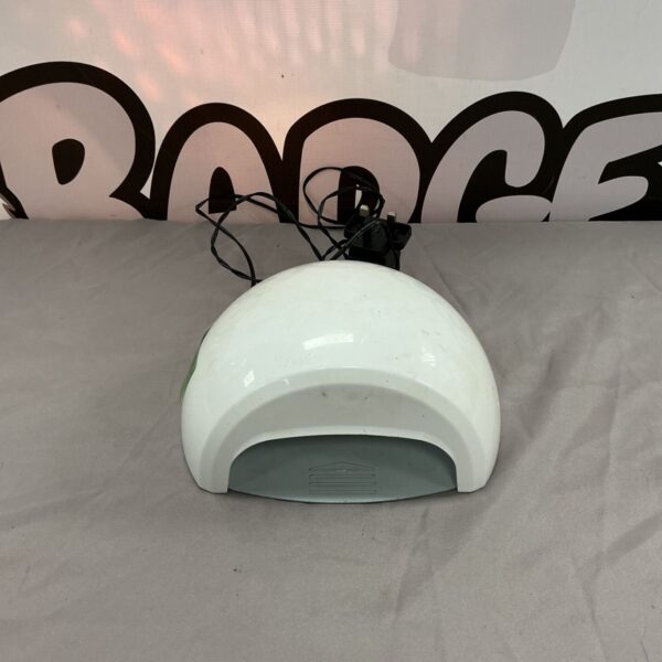 White dome-shaped LED nail dryer for manicure use.