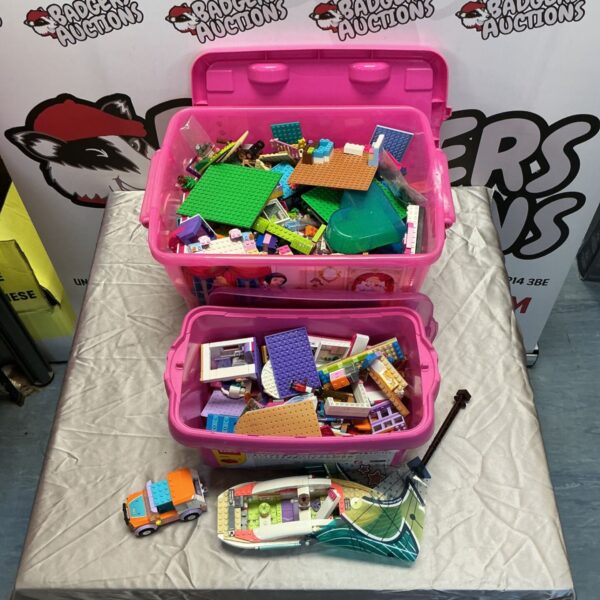 Assorted Lego Friends pieces in pink storage boxes.
