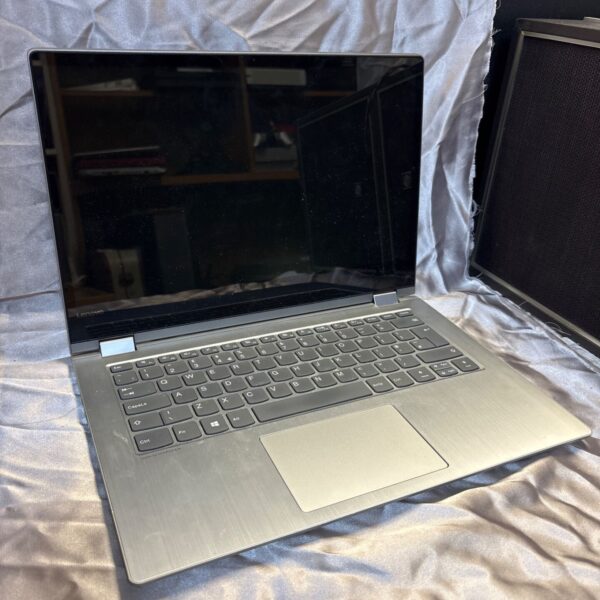 Lenovo Yoga 81EK laptop open, showing keyboard and screen.