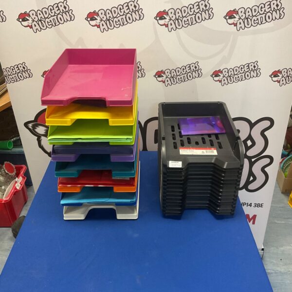 Stack of colourful plastic letter and file trays for office organisation.