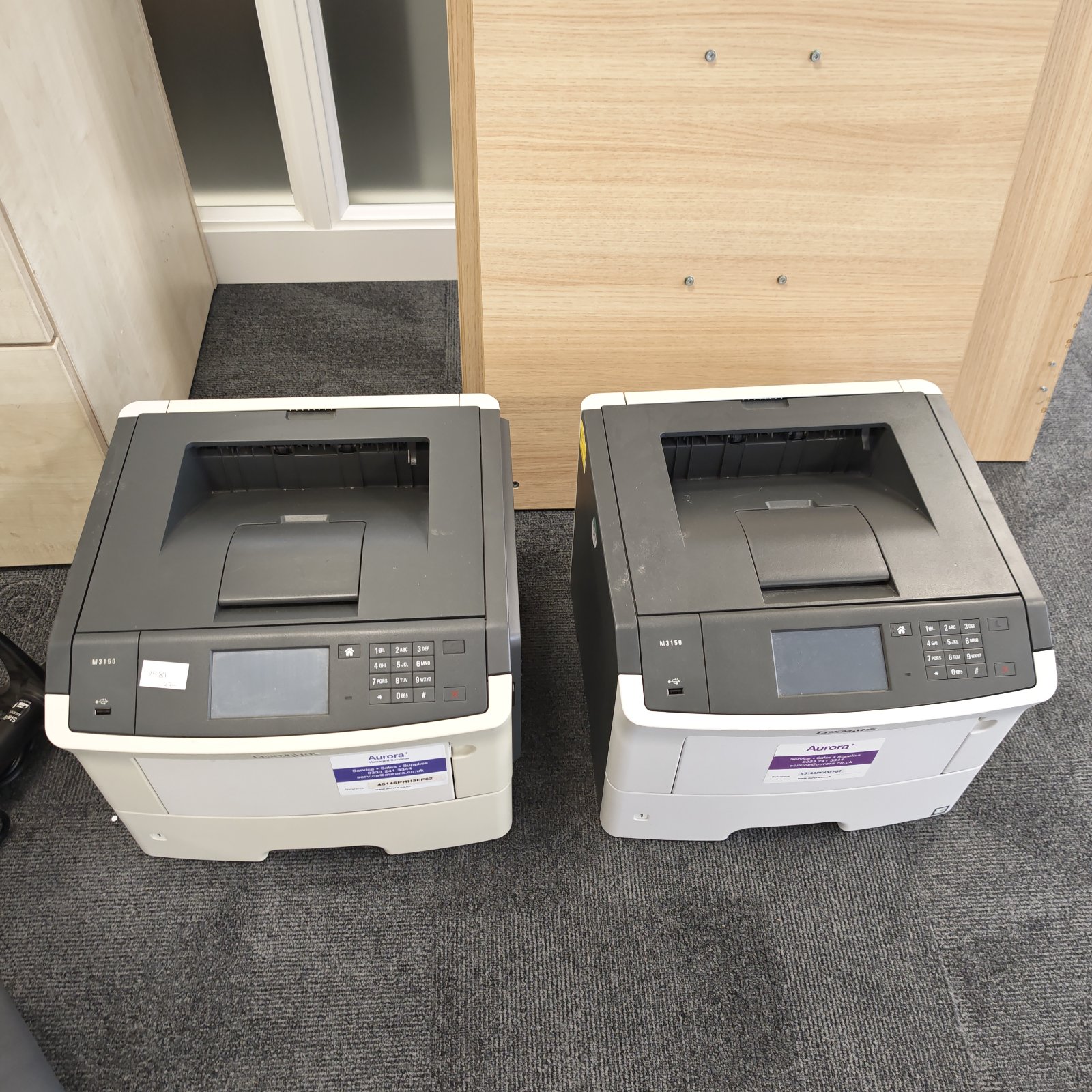 Two Lexmark monochrome laser printers, E260 and E360 models, for office use.