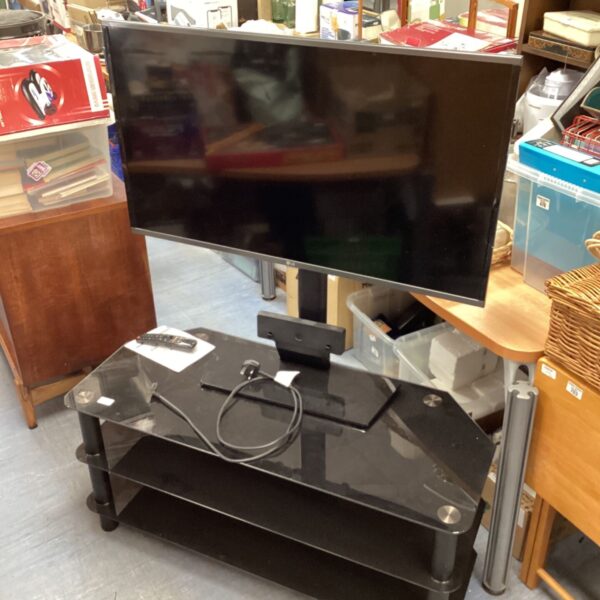 LG 40 inch smart TV with glass stand and remote control.
