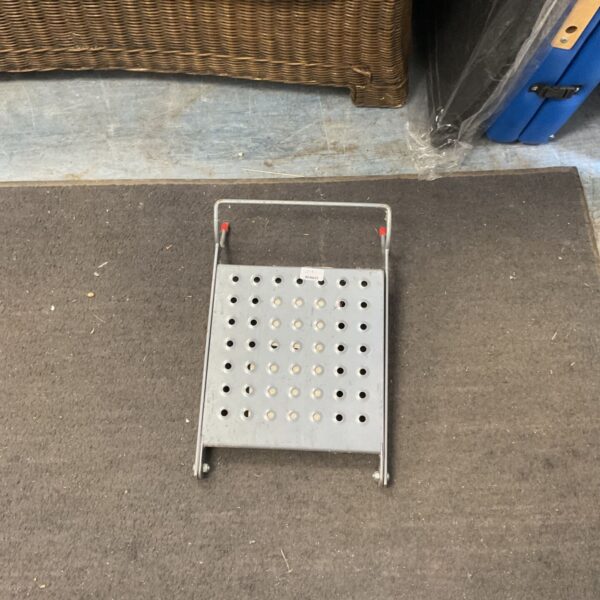 Little Giant ladder platform showing perforated metal surface and folding legs.