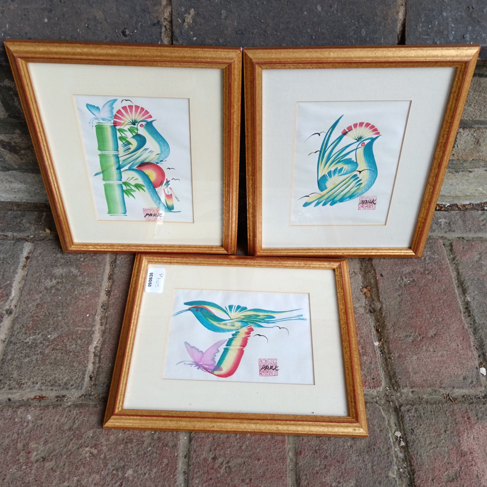 Three gilt framed oriental artworks of birds signed park