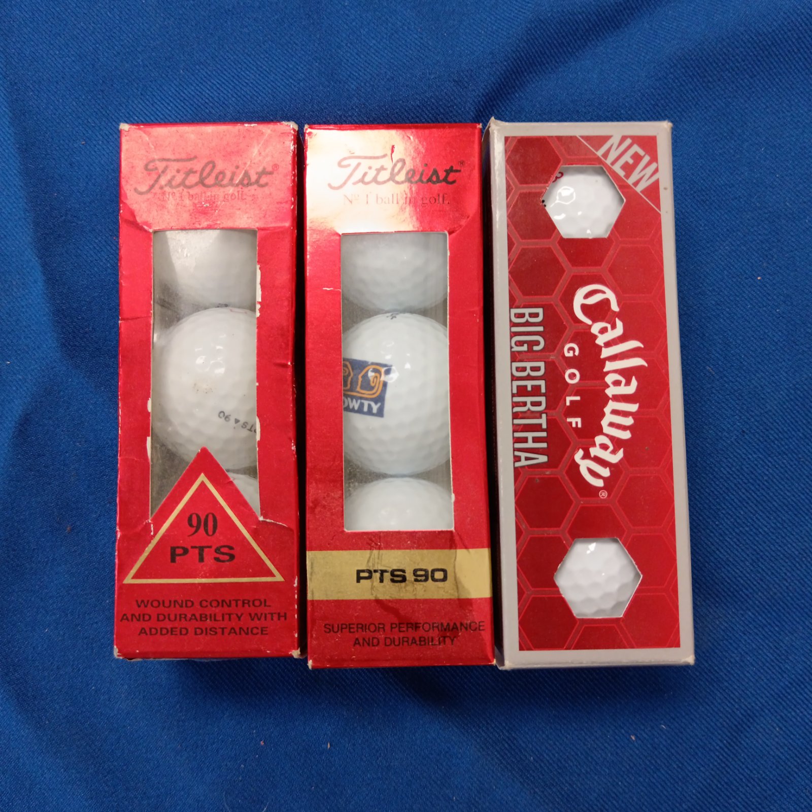 Three boxes of golf balls including Titleist & Callaway