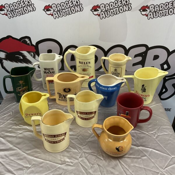 Collection of pub jugs, including teachers and bells, whiskey and Guinness mug