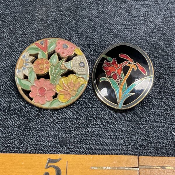 Two vintage brass and enamelled floral brooches