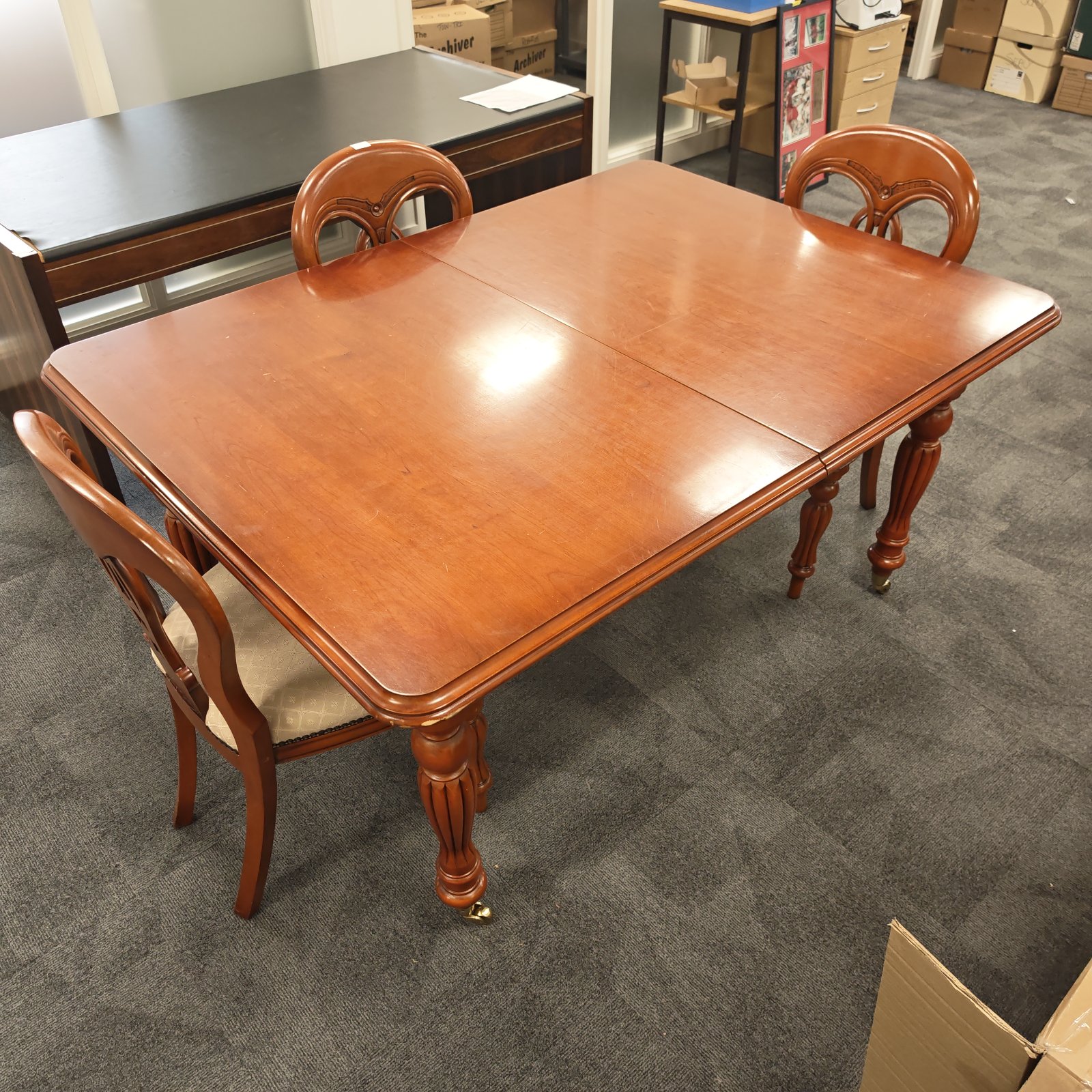 Cherry wood dining room table and three matching chairs