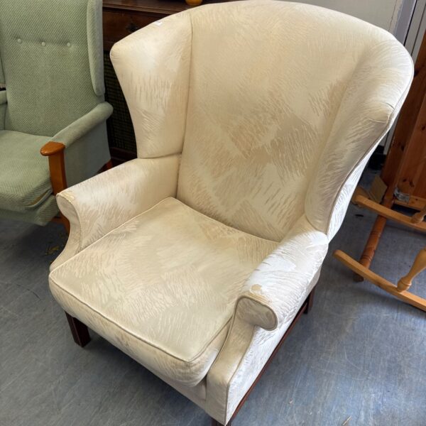 Large cream coloured wing back armchair 36” width x 43.5” height x 35” depth at furthest points approx - has some wear on arms