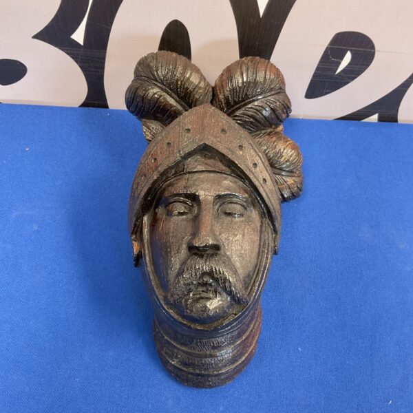 Antique carved wooden bust of a mediaeval knight wearing a plumed Morian helmet