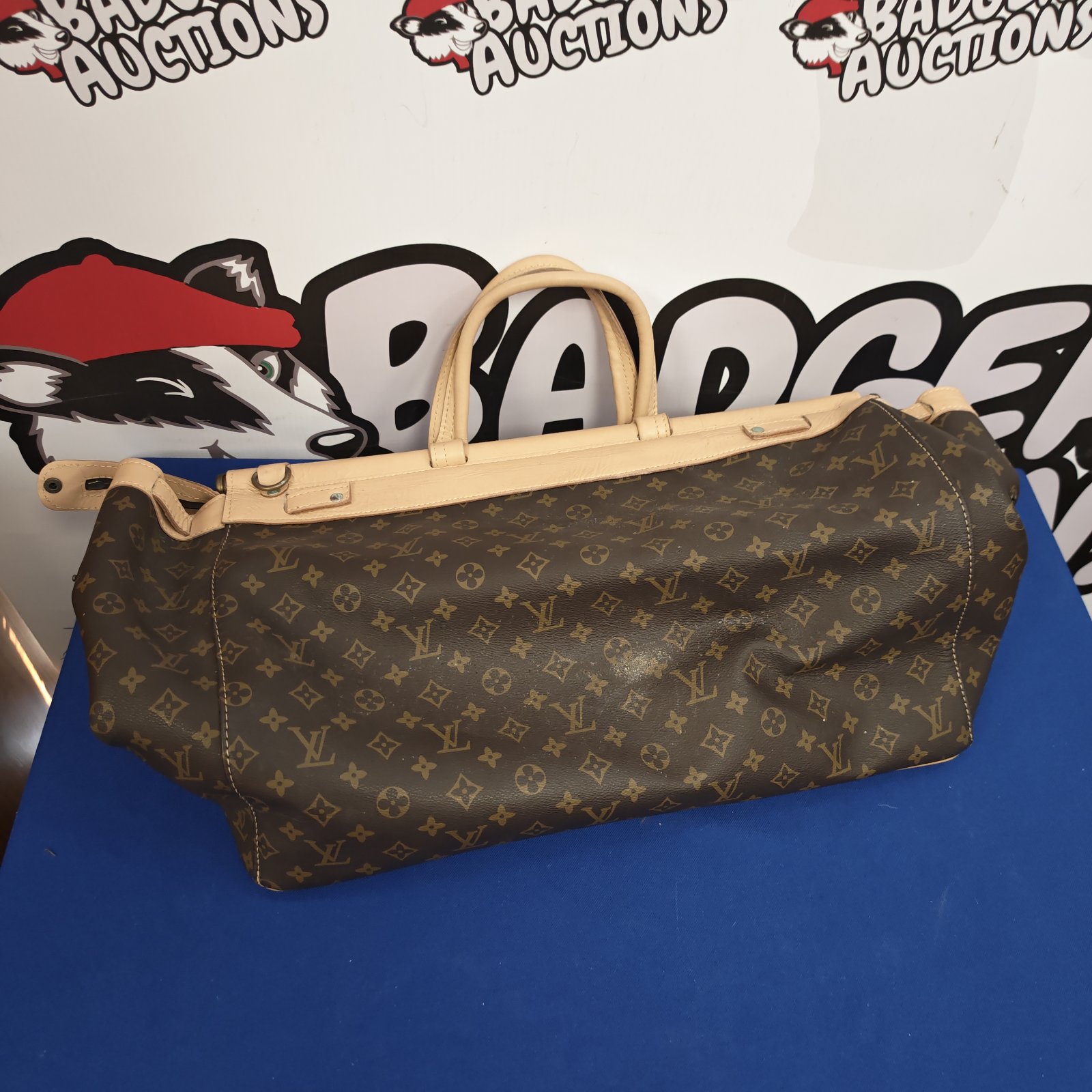 Louis Vuitton style handbag with monogram pattern and twin handles.
