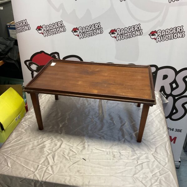 Antique mahogany folding table with a worn finish.