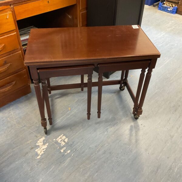 Vintage mahogany nesting tables with swivel top, side view.