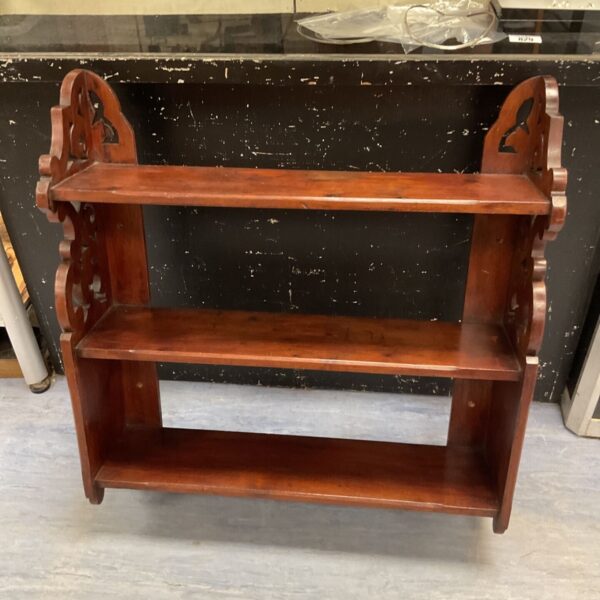 Antique mahogany wall shelf with three tiers, showcasing Art Nouveau curves.