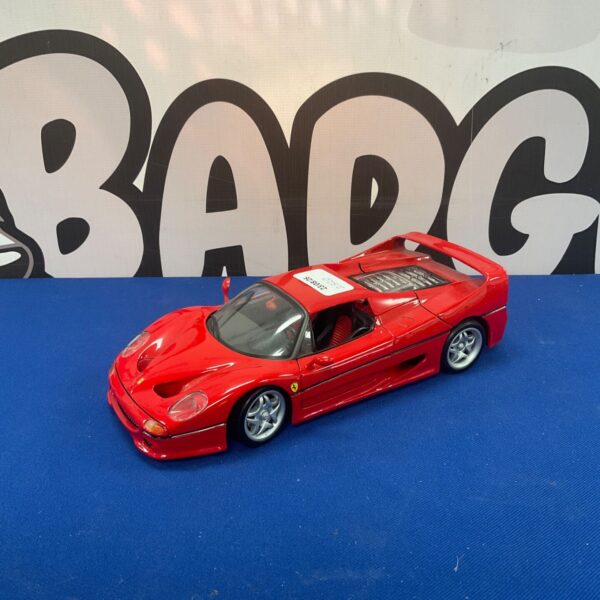 Red Maisto Ferrari F50 diecast model car on display.
