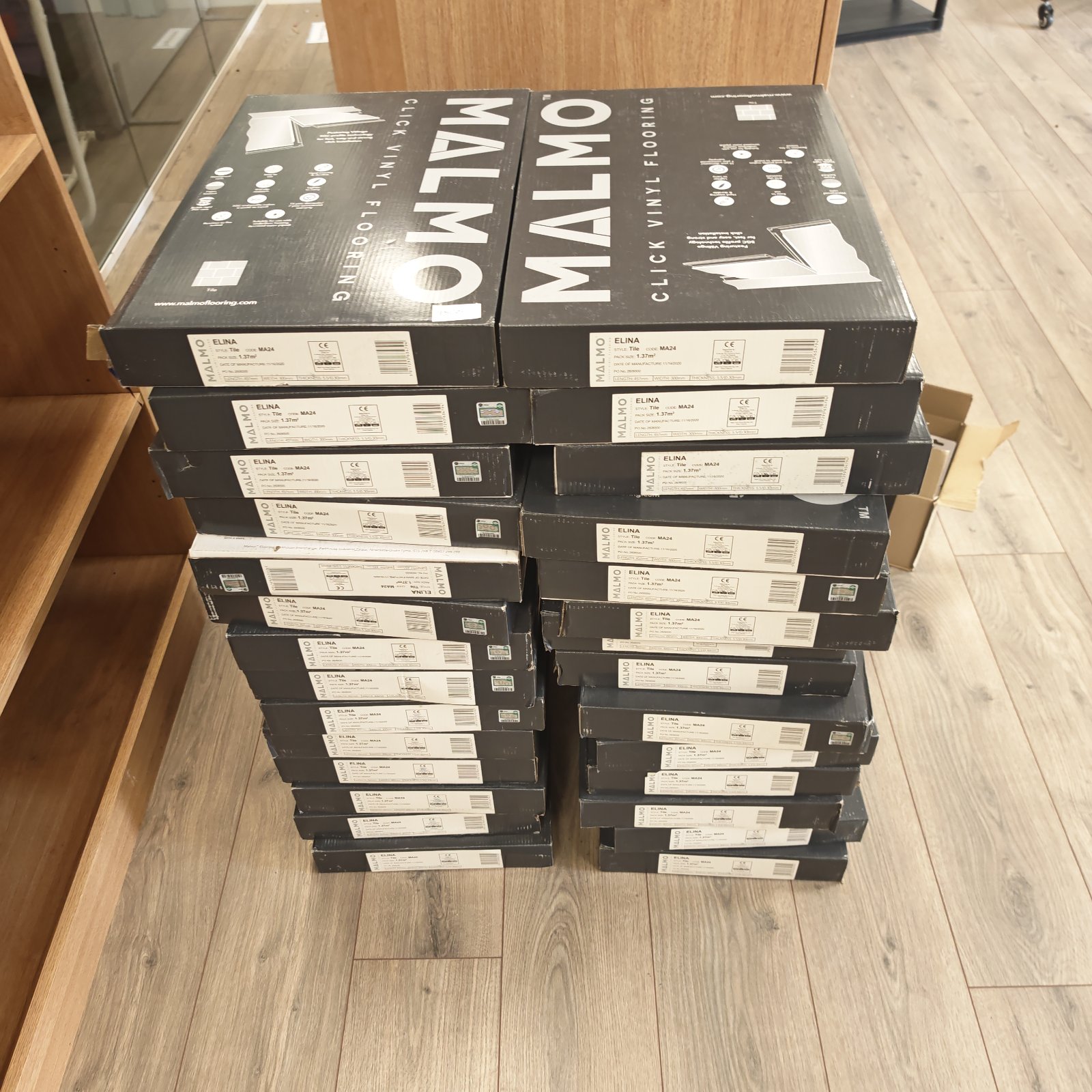 Sealed packs of Malmö click vinyl flooring ready for installation.