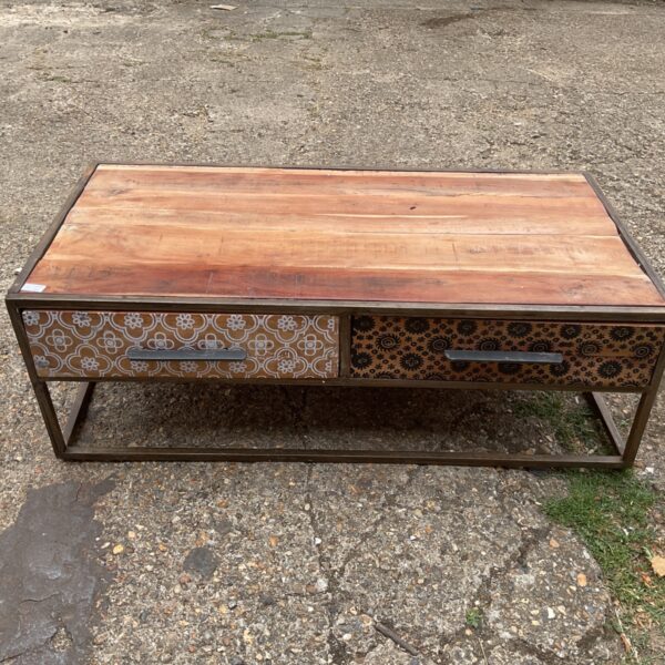 Rustic mango wood coffee table with floral carved drawers.