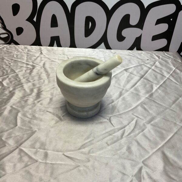 Vintage marble pestle and mortar set for grinding spices.
