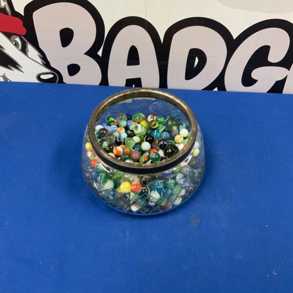 Colourful marbles displayed in a clear glass bowl.