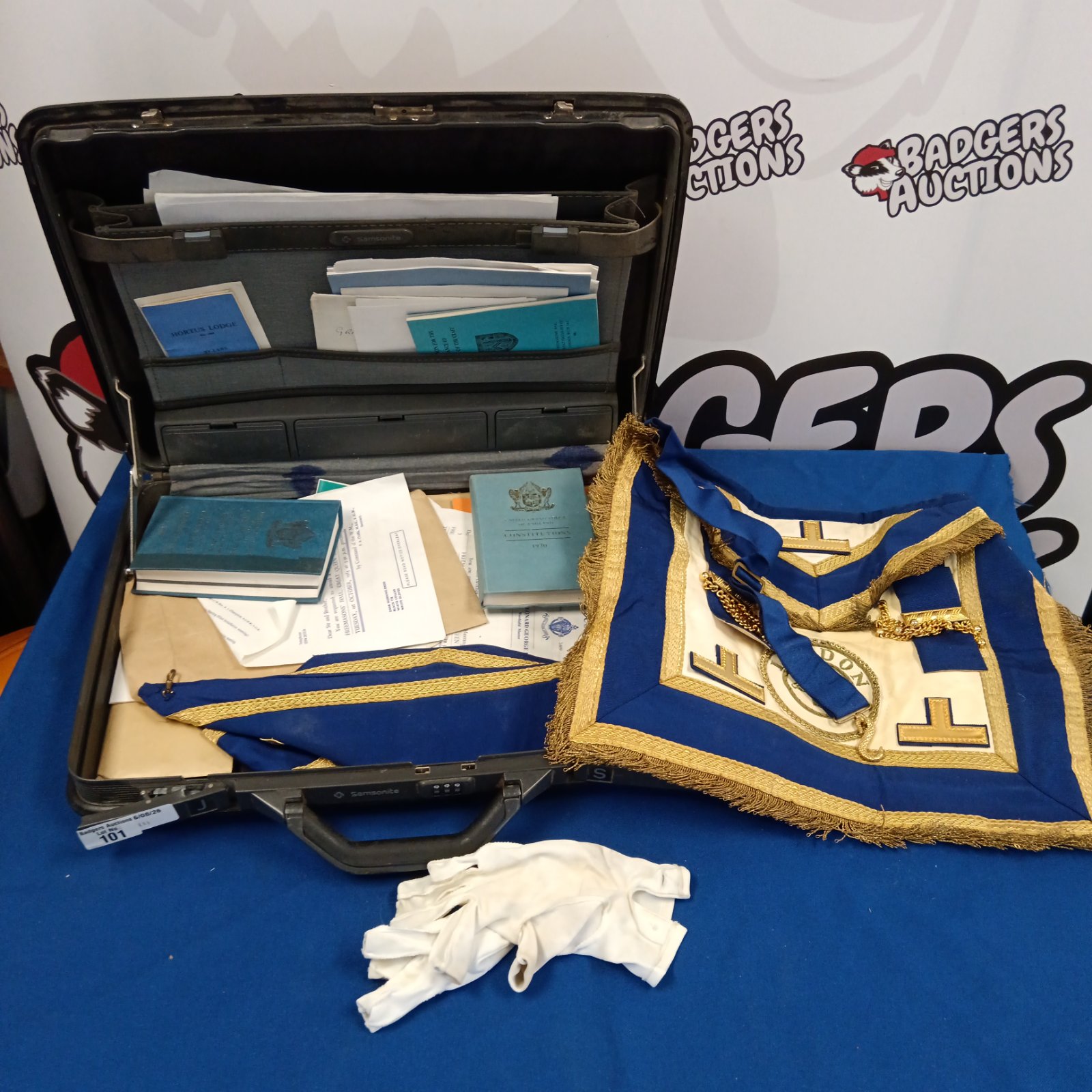 Vintage Masonic aprons and documents inside a carrying case.