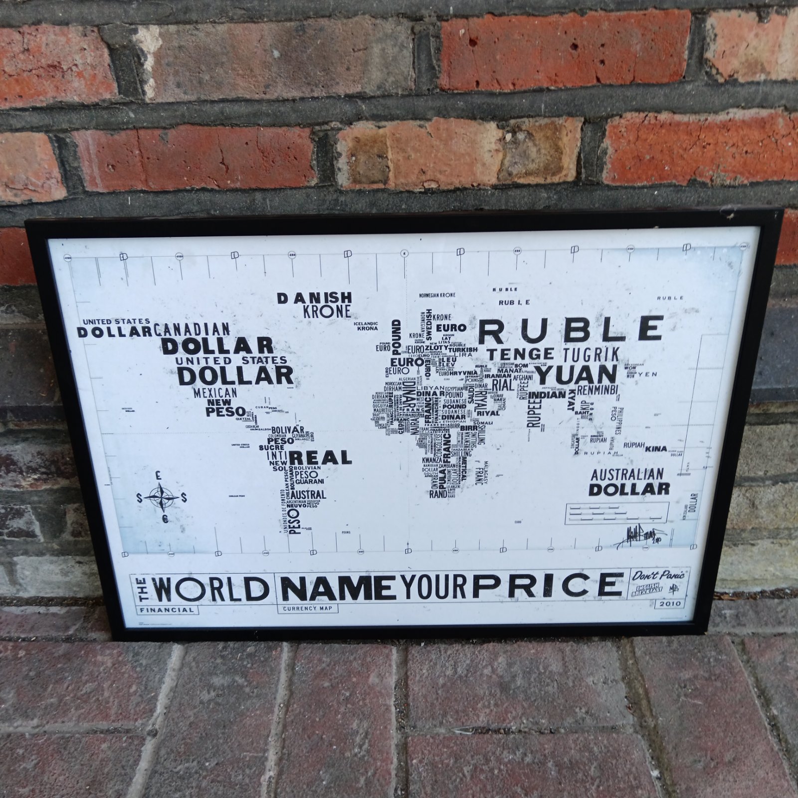 Framed Matt Bonner "The World Name Your Price" currency map art print.