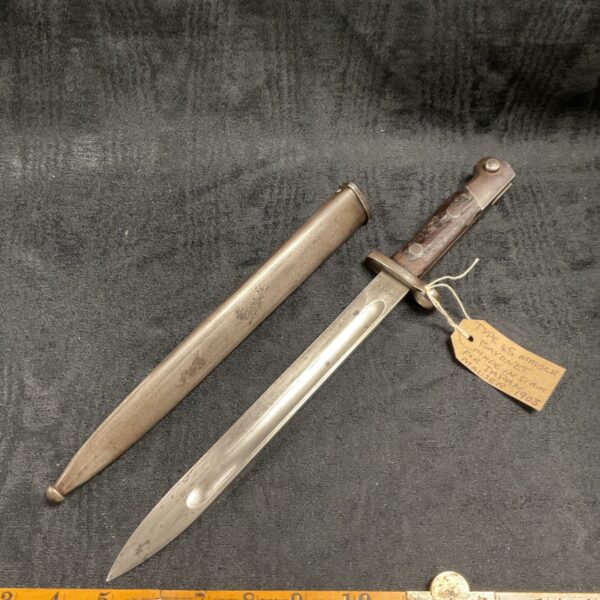 Antique Mauser bayonet with wooden grip and scabbard.