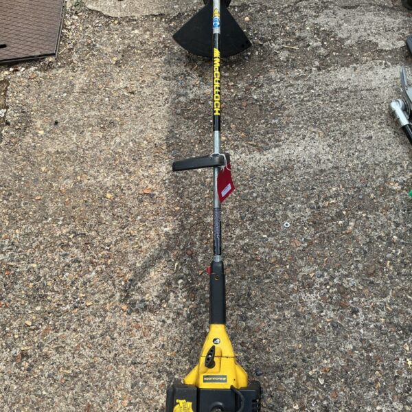 Vintage McCulloch petrol strimmer, yellow and black garden tool.