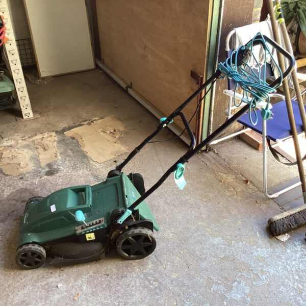 Green McGregor cordless lawnmower in a garden setting.