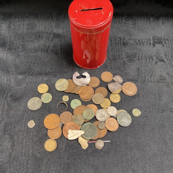 Metal detector coin lot with mixed antique coins in a red tin.