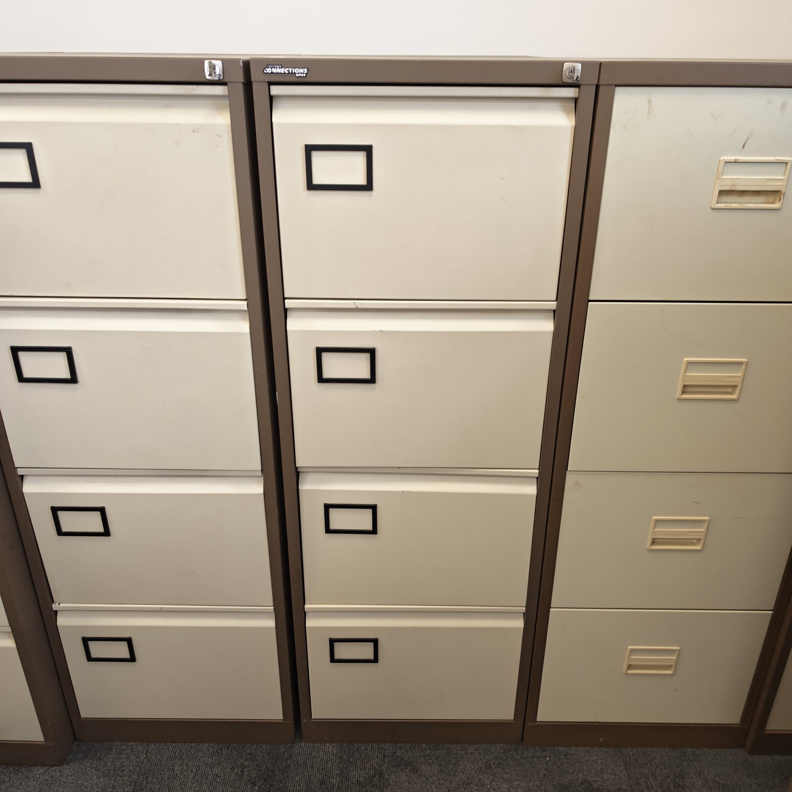 Vintage four-drawer metal filing cabinet for office storage.