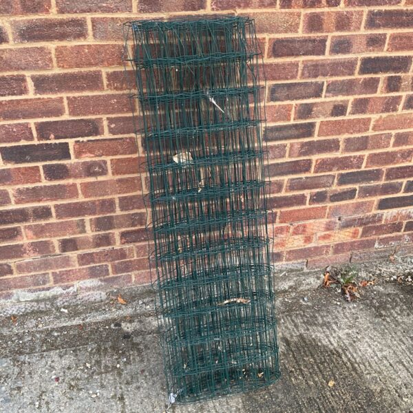 Section of metal garden fencing with diamond pattern.