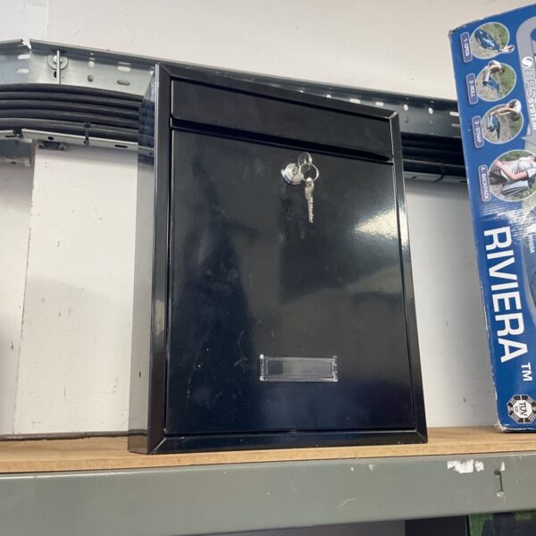 Vintage metal letterbox with keys for secure mail delivery.