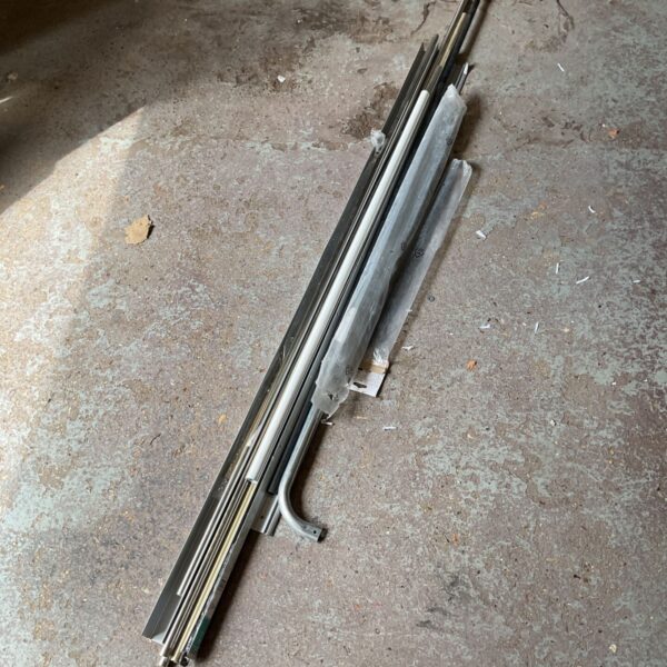 Mixed lot of metal poles, rails, and handles for DIY projects.