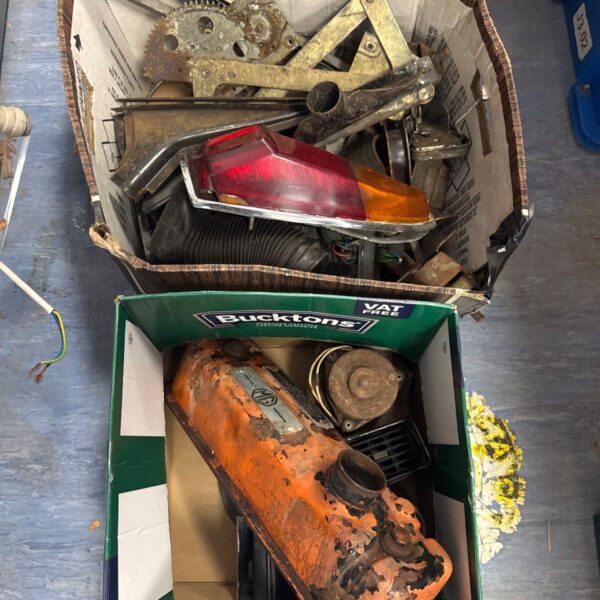 Assorted MGB car parts in two boxes, classic car restoration.