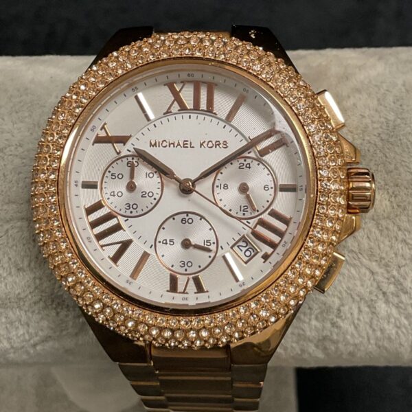 Gold tone Michael Kors wristwatch with Roman numeral dial.