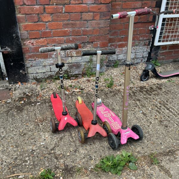 Lot of three Micro balance scooters for children's outdoor play.