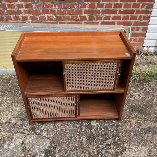 Mid-century modern wooden cabinet with cane doors for stylish storage.